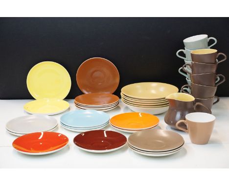 Collection of Poole vintage tea set items in varying retro colour ways to include twelve tea cups, twelve saucers, milk jug, 