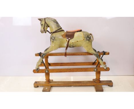 Late 19th / early 20th Century Triangtois rocking horse having painted wooden body with glass eyes and horse hair tail, raise