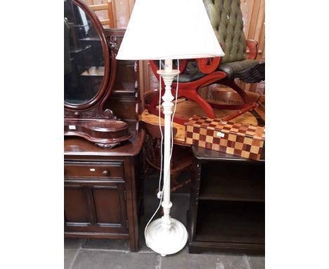 A cream painted standard lamp. 