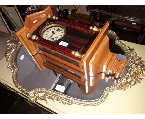 A vintage metal framed mirror together with a wall clock with pendulum and key. 