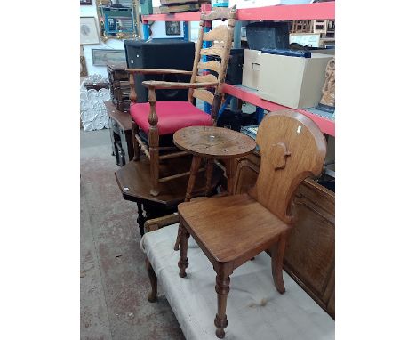 Four pieces of furniture comprising a 19th century oak hall chair, an ash ladder back chair, a mahogany occasional table and 