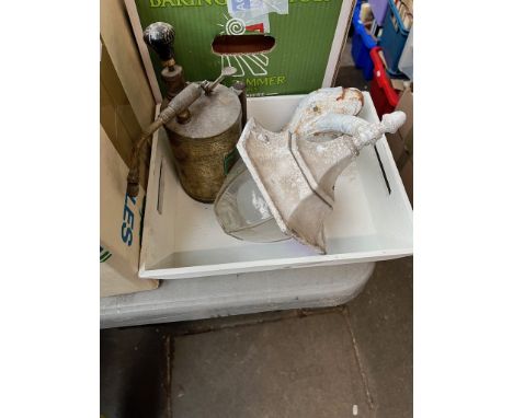 A white painted tray with a vintage paint sprayer and an outdoor lamp. 