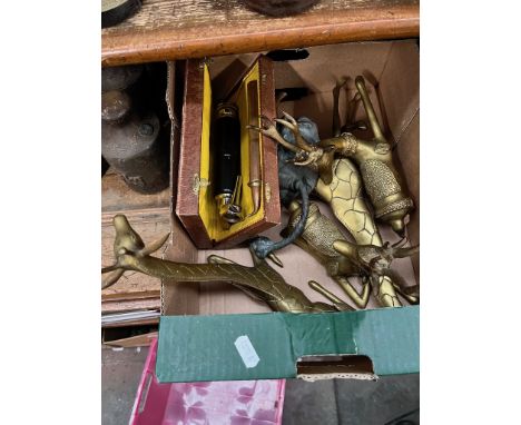 A selection of brass items to include two giraffes, two reindeers, a door knocker in shape of lion's head and an apparatus in