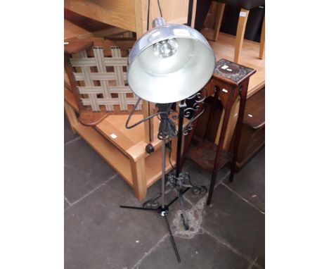 An industrial style aluminium lamp on adjustable tripod base. 