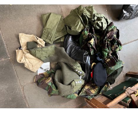 A bag of military clothing including trousers, boots, peaked cap, sweater, camouflage wear, beret, shirt, epaulettes etc 