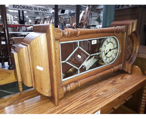 An oak cased Vienna style chiming wall clock with pendulum and key. 