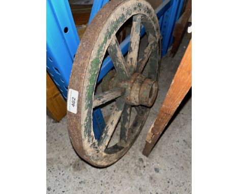 A vintage small wooden cart wheel. 