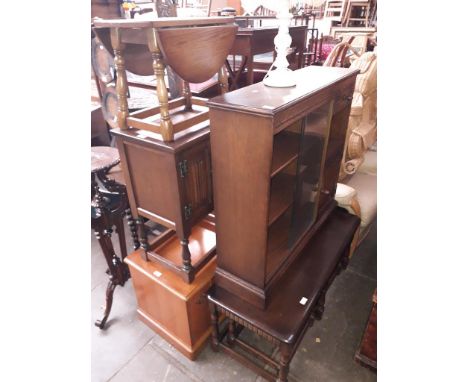 Various items of furniture; an oak nest of tables, an Old Charm oak bookcase with sliding glass doors, a white table lamp, a 