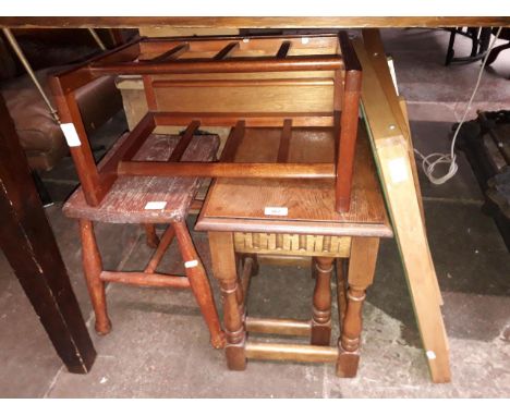 Four items of furniture; an oak nest of tables, a vintage stool, a mid 20th century magazine rack and a card table with green