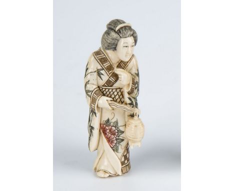 A Japanese carved ivory netsuke of a Geisha early 20th century, polychrome and bamboo design decoration, carrying a lantern, 