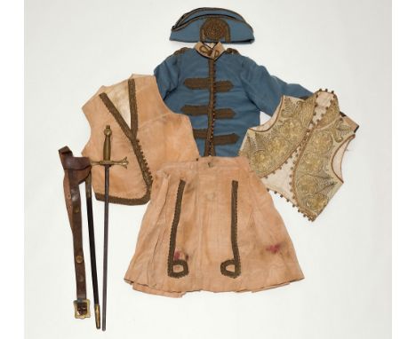 A Victorian child's Russian-style military uniform comprising a blue felt tunic with black edge piping, gold brocade strapwor