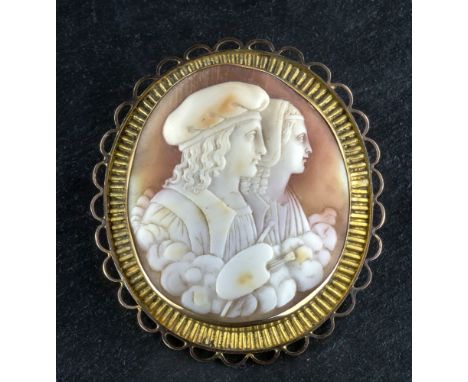 A yellow gold and shell cameo brooch of an artist & companion late 19th / early 20th century, the convex cameo well carved wi