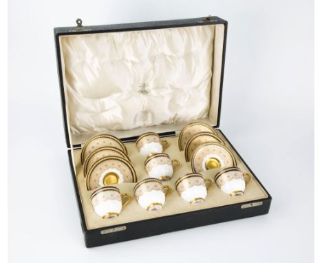A cased Royal Worcester coffee service 1920, six cups with white ground and gilt interior and handles, cobalt blue borders to