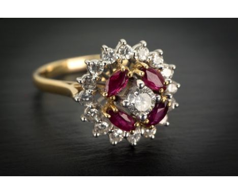 A fine Garrard & Co. 18ct gold, ruby and diamond cluster ring London c.1975, the centre brilliant cut diamond above four marq