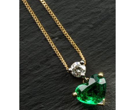 An 18ct yellow gold, Zambian emerald and diamond pendant the heart shaped emerald, size 0.7 carats, below a single round bril