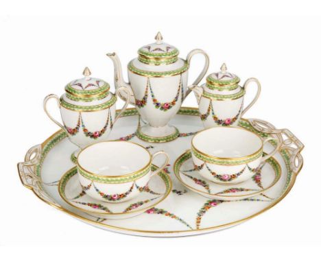 A Continental porcelain tête-a-tête cabaret set 20th century, comprising 15in. circular tray with pierced handles, two cups a