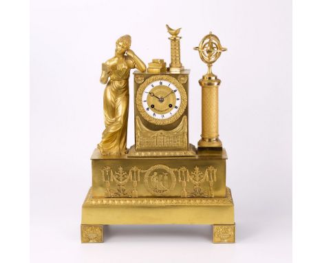A French gilt metal mantle clock 19th century, decorated with iconography on the theme of arts and sciences, to the left a ma