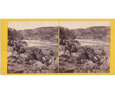 A Channel Islands stereoview card two fishermen on the rocks at Saints Bay, Guernsey, by T. B. Hutton, pasted title verso.