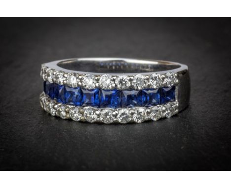 An 18ct white gold, sapphire and diamond ring with nine square cut sapphires, total weight 0.72 carats, channel set within bo