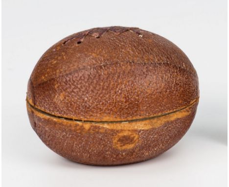 A Victorian novelty travelling rugby ball inkwell covered in dark tan leather with stitching detail to the cover, the gilt br