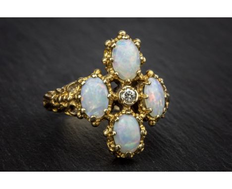 A 9ct gold, opal and diamond Victorian style ring London c.1972, the open four lobed setting with four oval opals and central