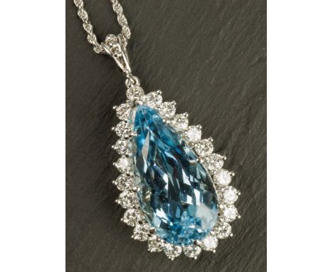 An 18ct white gold, aquamarine and diamond cluster pendant the pear cut aquamarine within a border of twenty-three round bril