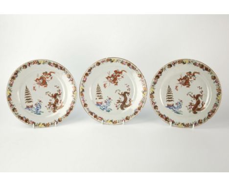 A set of three late 18th century Chinese export plates enamel decoration, borders with trailing sequence of stylised emblems,