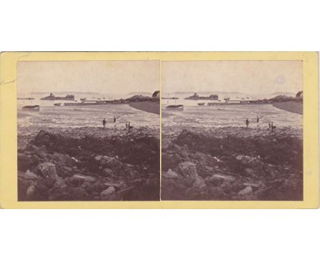 A Channel Islands stereoview card depicting shore gatherers at low tide on Bordeaux Harbour, Guernsey, the islands of Herm an