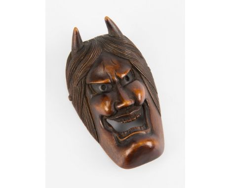 A Japanese carved wooden Netsuke 19th century, modelled as a Noh mask of Hann'nya, signed to reverse for Shokin, 5.2cm. long.