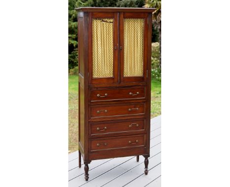 A French tall brass inlaid mahogany side cabinet late 19th century, the grey marble top over a pair of grille doors with gold