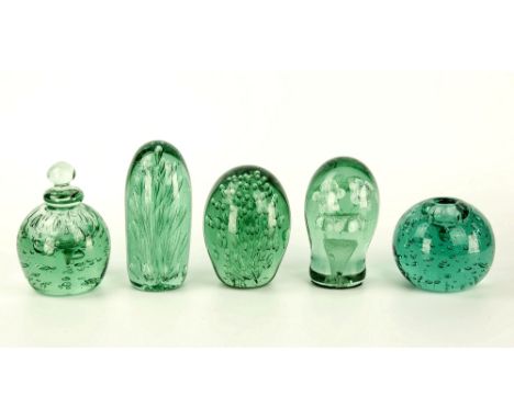 Five 19th century green glass dump paperweights Nailsea influence, one an inkwell with lid, four bearing interior bubbles, a 