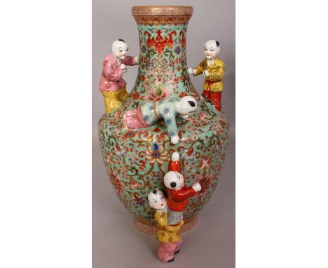 A CHINESE TURQUOISE GROUND FAMILLE ROSE PORCELAIN BOYS VASE, decorated with formal scrolling lotus and moulded in high relief