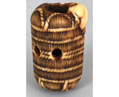 A JAPANESE MEIJI PERIOD IVORY NETSUKE OF A RAT ON A STRAW BALE, unsigned, the rat's head burrowed into the rope bound bale, 1