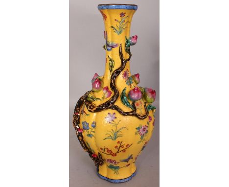 A CHINESE FAMILLE ROSE YELLOW GROUND PORCELAIN VASE, of quatrefoil section, the sides moulded with branches of peach reserved