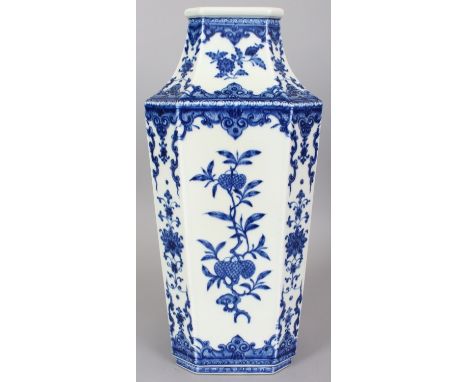 A LARGE CHINESE MING STYLE BLUE & WHITE PORCELAIN VASE, the sides of the chamfered square-section body decorated with extende