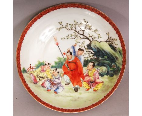 A CHINESE FAMILLE ROSE PORCELAIN SAUCER DISH, the interior painted with a scene of a halberd bearing Immortal and boys in a f