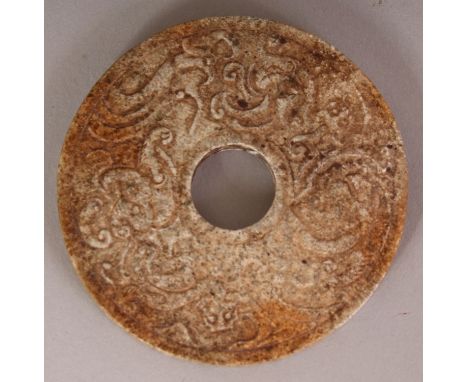 A CHINESE ARCHAIC JADE LIKE DISC, each side decorated in shallow relief with chilong, 2.3in diameter.