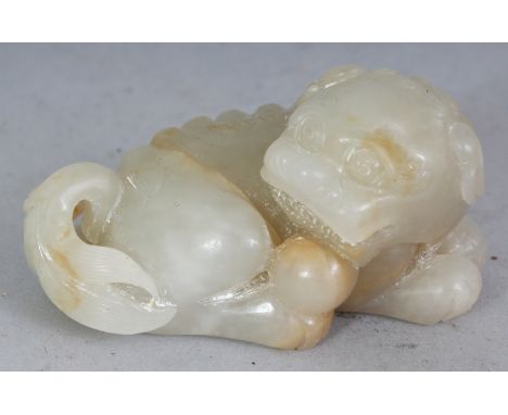 A GOOD QUALITY CHINESE CELADON GREEN JADE MODEL OF A BUDDHISTIC LION, with a ball between its chin and one of its paws, the p