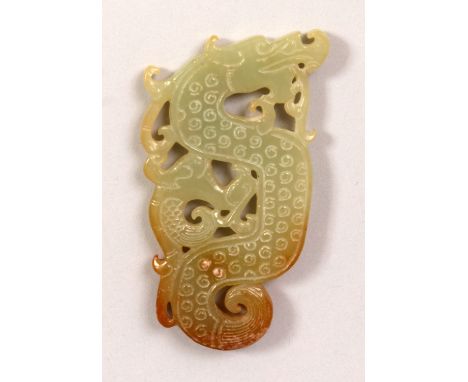 A CHINESE CELADON PIERCED JADE DRAGON PLAQUE, the stone with russet inclusions, 3in long.