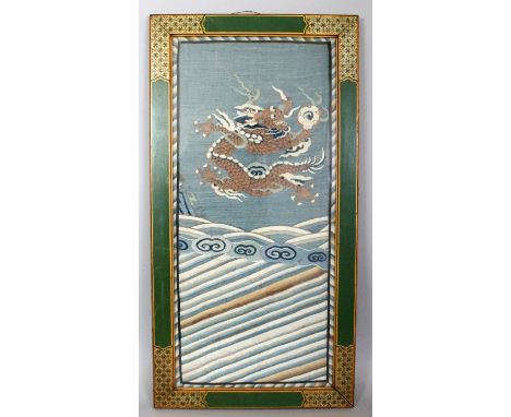 A GOOD EARLY 20TH CENTURY FRAMED CHINESE KESI DRAGON PANEL, decorated with a dragon grasping a flaming pearl above stylised w