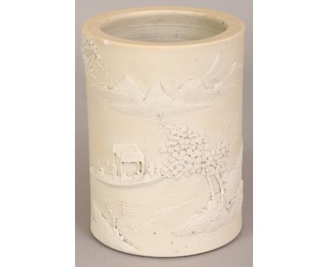 A 19TH/20TH CENTURY CHINESE WHITE WANG BINRONG BISCUIT PORCELAIN BRUSH POT, the sides moulded with a mountainous river landsc