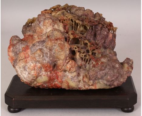 AN UNUSUAL 19TH/20TH CENTURY CHINESE SOAPSTONE BOULDER, together with a fitted wood stand, the soapstone carved in the form o