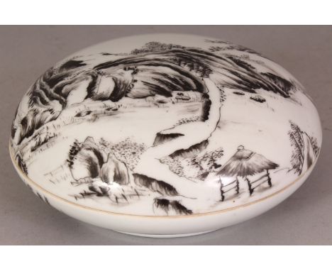 A CHINESE REPUBLIC STYLE CIRCULAR PORCELAIN BOX & COVER, decorated in black enamel with a river landscape setting, the base w