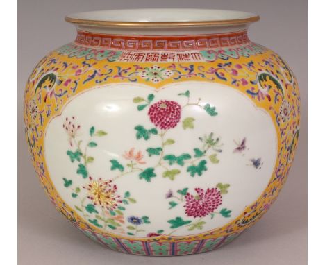 A CHINESE YELLOW GROUND FAMILLE ROSE PORCELAIN VASE, with shaped floral panels reserved on a ground of scrolling lotus, the b