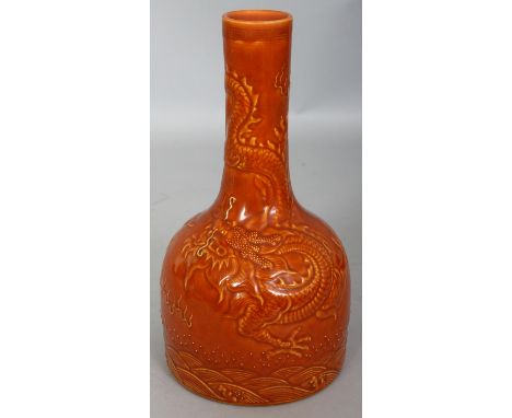 A CHINESE OCHRE GLAZED MALLET FORM PORCELAIN DRAGON VASE, the sides with underglaze moulded decoration, the base with a Qianl