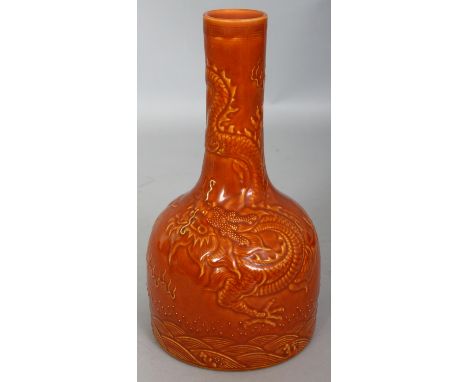 A CHINESE OCHRE GLAZED MALLET FORM PORCELAIN DRAGON VASE, the sides with underglaze moulded decoration, the base with a Qianl