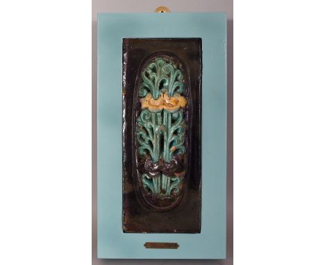 AN UNUSUAL MOUNTED CHINESE MING DYNASTY FAHUA GLAZED CERAMIC TILE, the raised oval surface pierced with a design of lotus, th