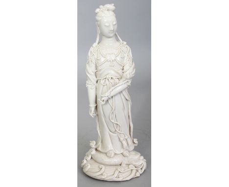 A FINE QUALITY EARLY 20TH CENTURY CHINESE REPUBLIC PERIOD BLANC-DE-CHINE PORCELAIN FIGURE OF GUANYIN, standing on a dragon pl