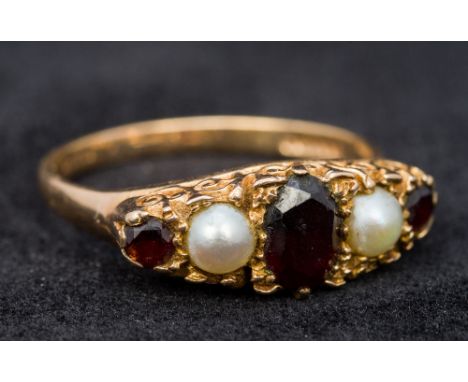 A 9 ct gold ruby and seed pearl set ring (size T/U, approximately 4 grammes all in).