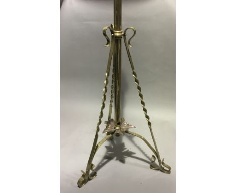 An Arts and Crafts brass standard lamp